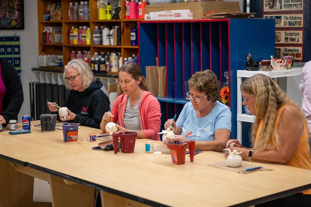  Pulaski staff members glazing their pumpkins during the second night of Pulask’s Art Club Make Your
