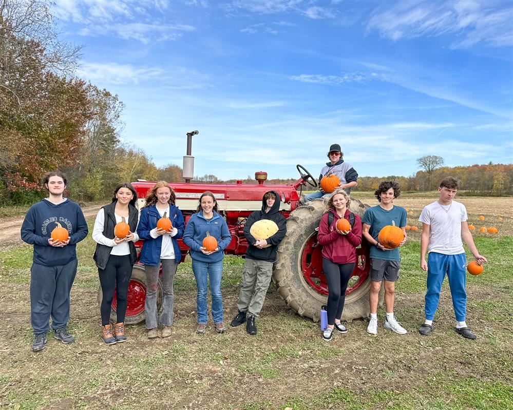  Pulaski High School students showing off their freshly picked pumpkins.
