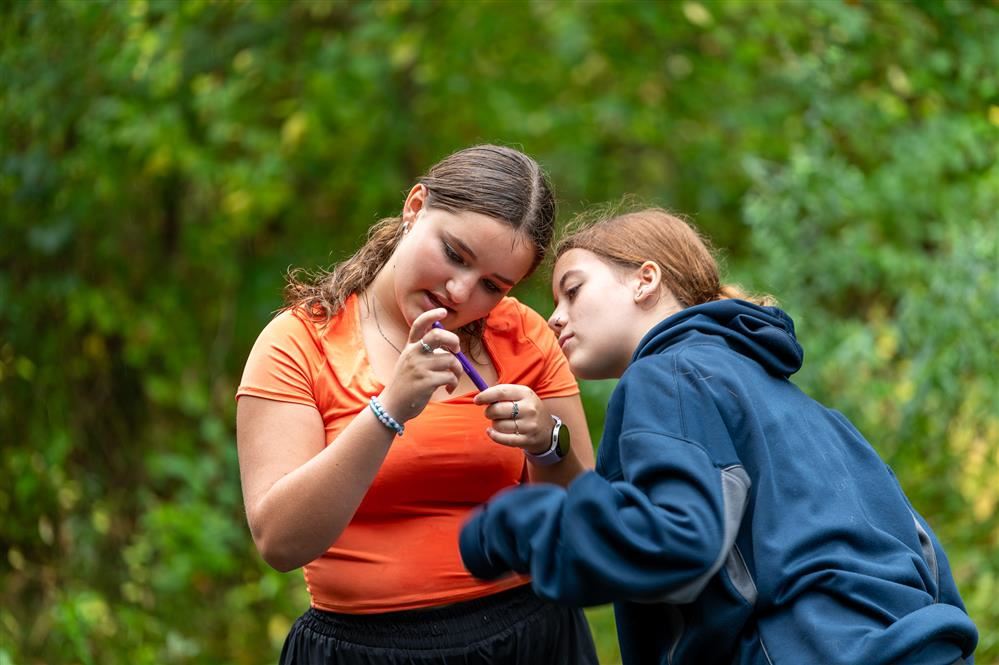  Two students from Pulaski Middle School observe an instrument after using it to test water.