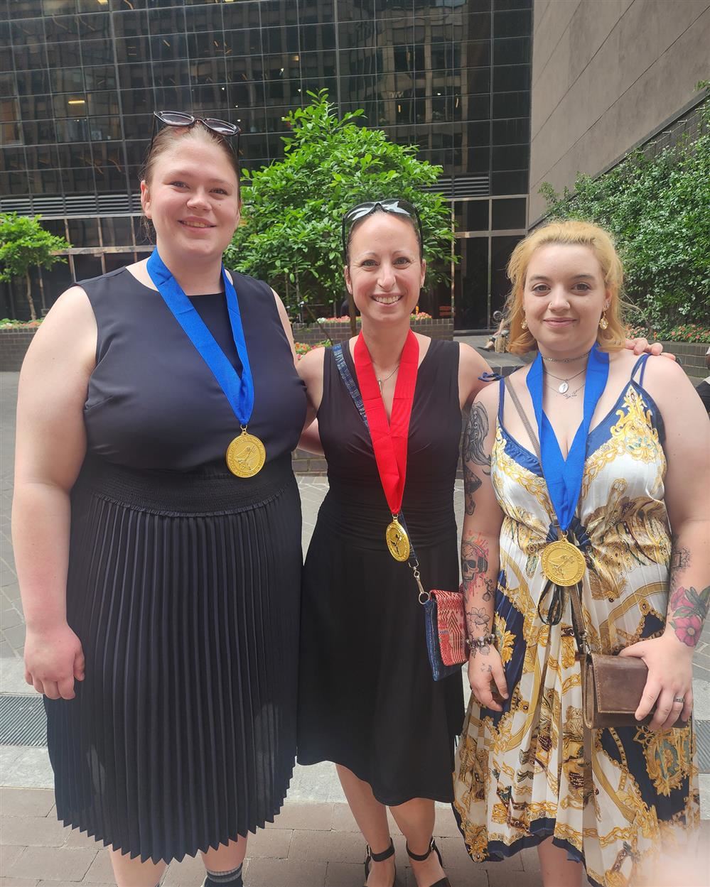 Hefti (left) and Spadi (right) both wearing their gold medals, standing with Pulaski Art Teacher, S